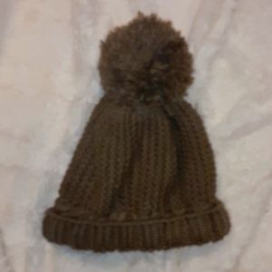 Is a winter hat with puffball on top